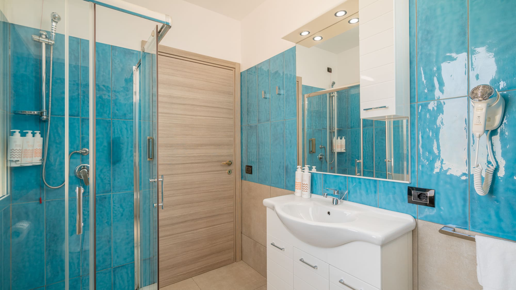 a bathroom with blue tiles