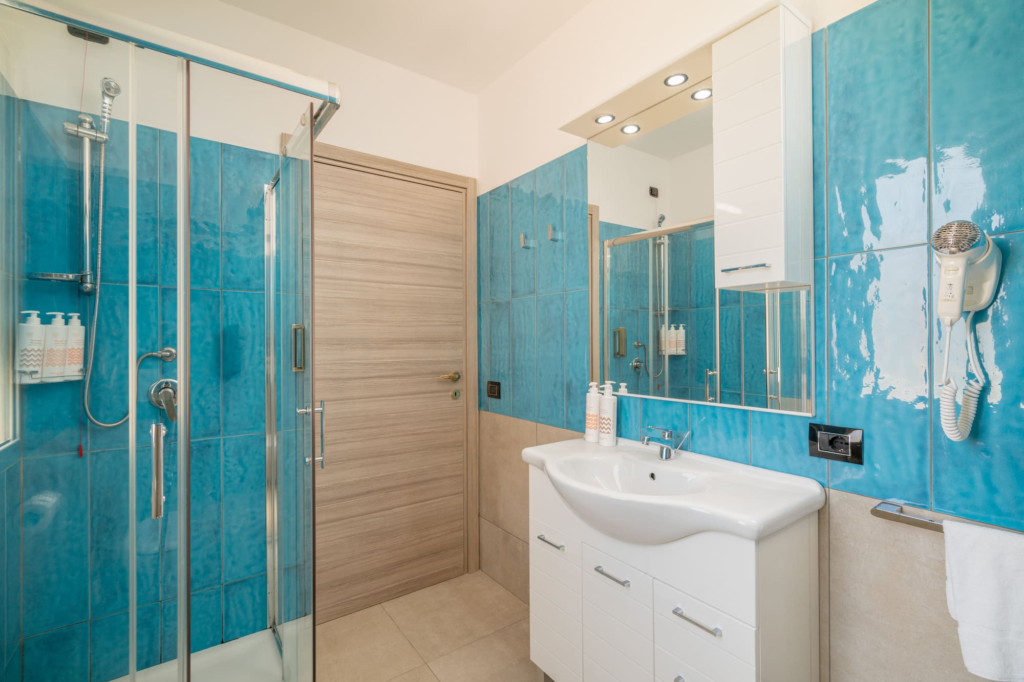 a bathroom with blue tiles