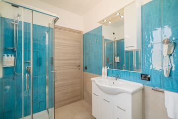 a bathroom with blue tiles