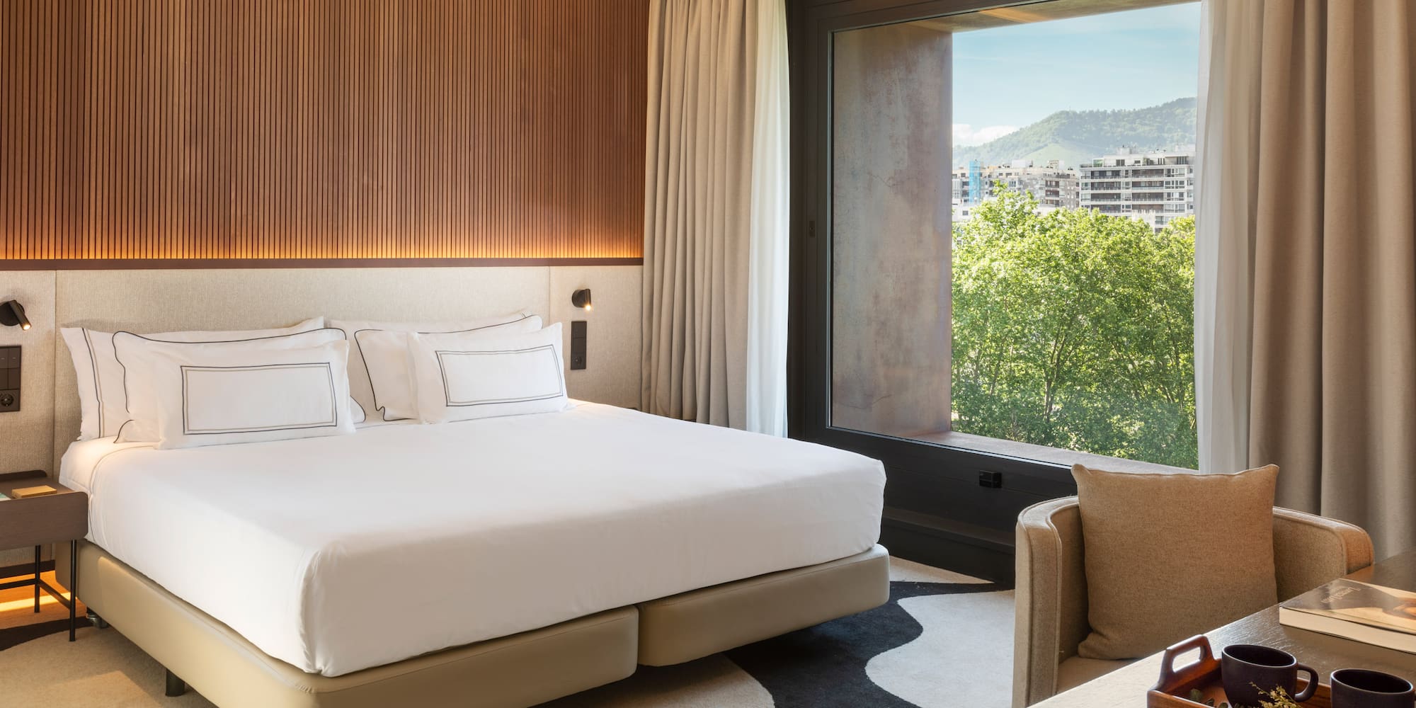 a room with a bed and a chair and a table