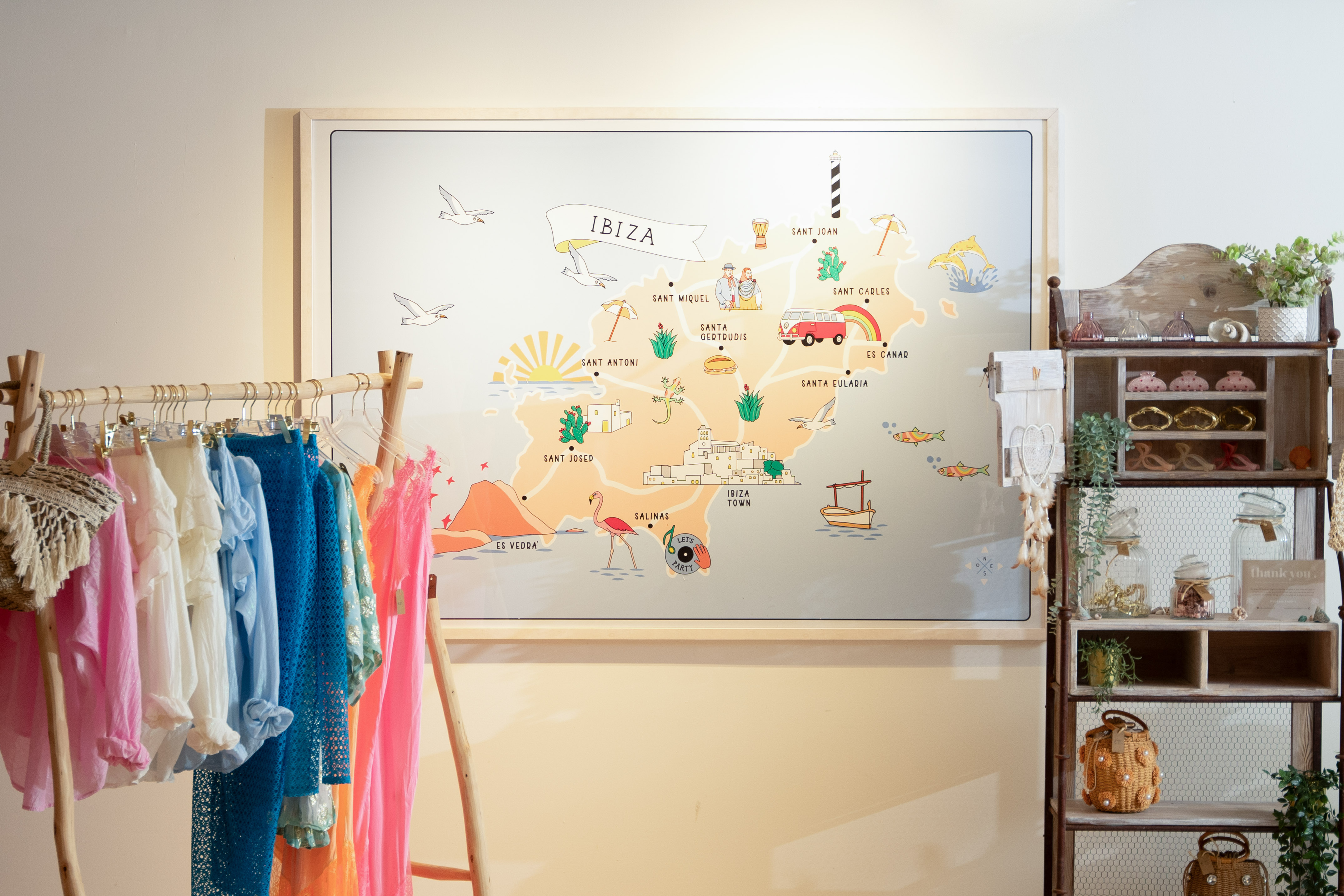 Colorful boutique fashion, accessories, and an illustrated Ibiza map display.