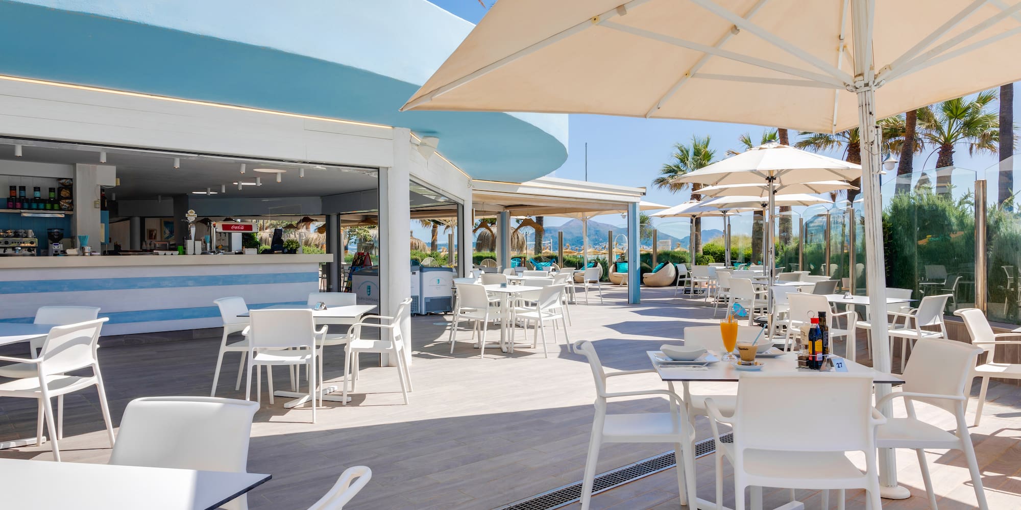 a restaurant with tables and umbrellas