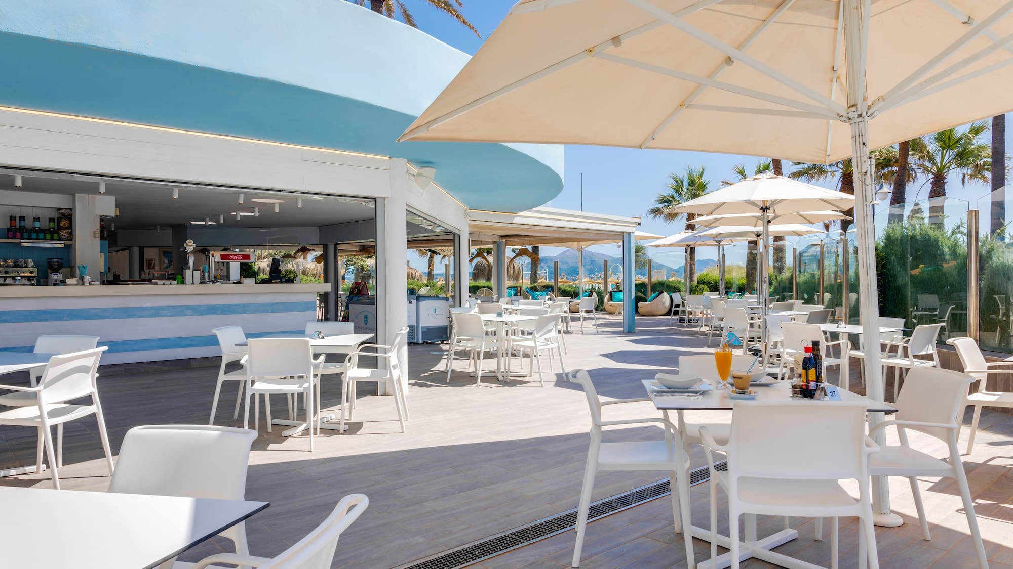 a restaurant with tables and umbrellas