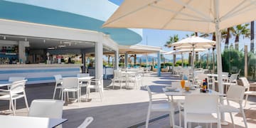 a restaurant with tables and umbrellas
