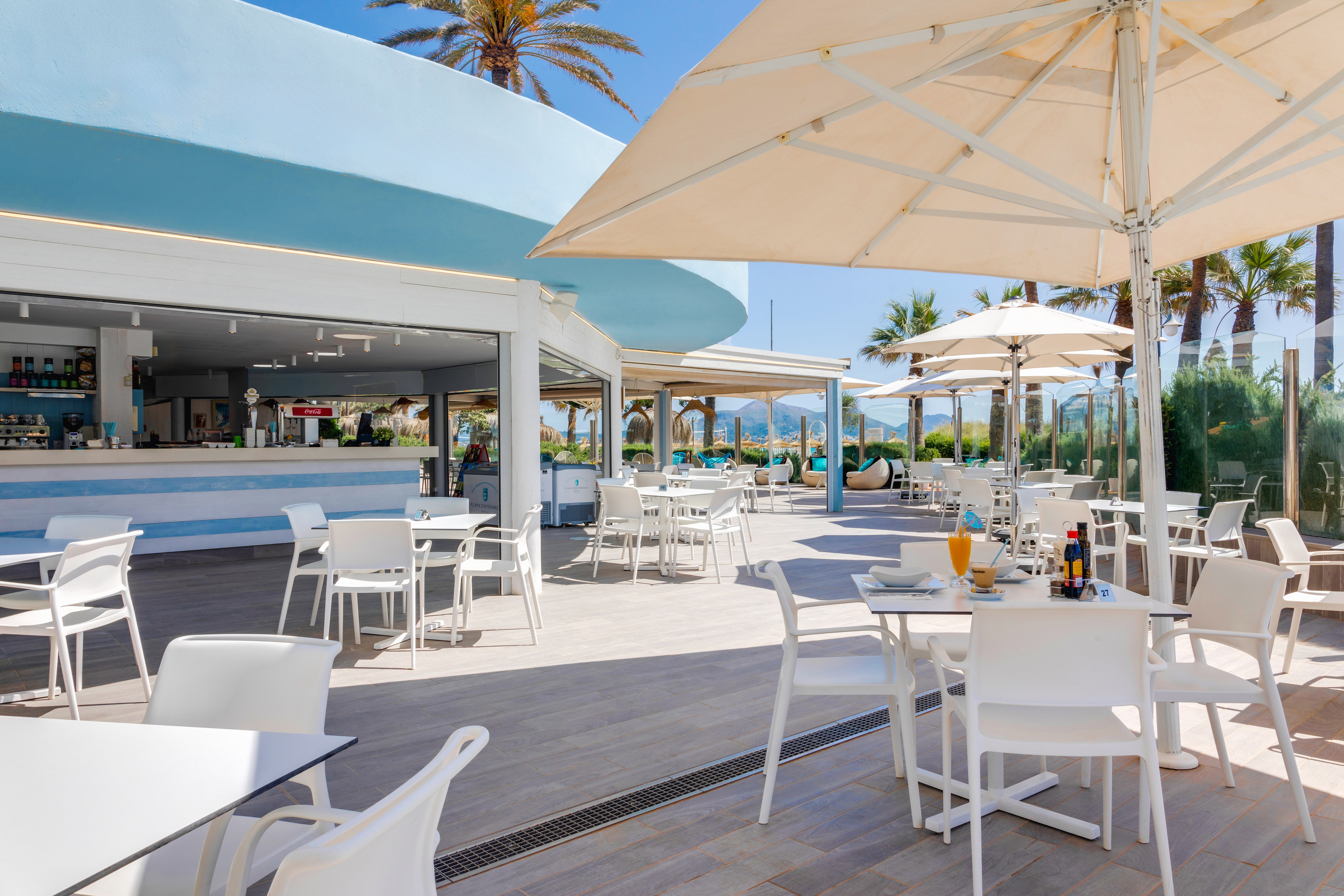 a restaurant with tables and umbrellas
