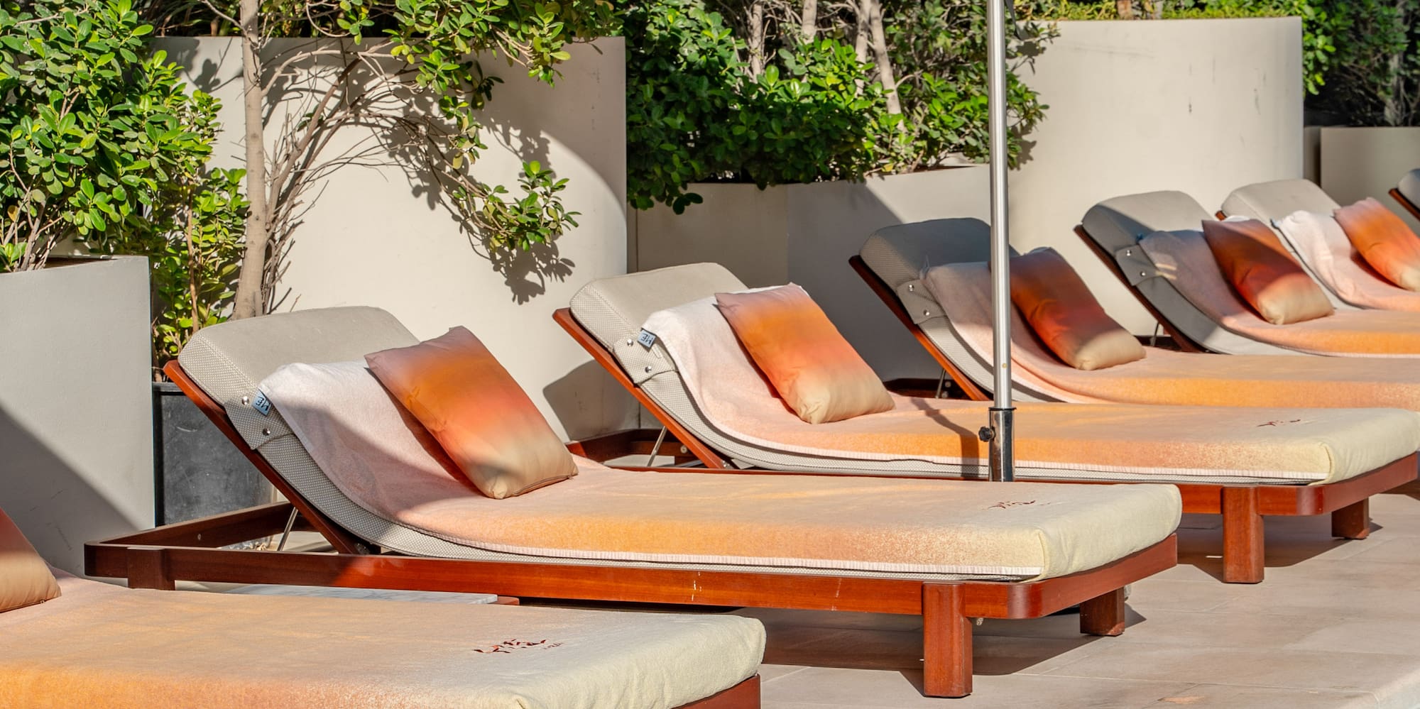a pool with lounge chairs and umbrellas