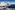 a snowy mountain range with a small village