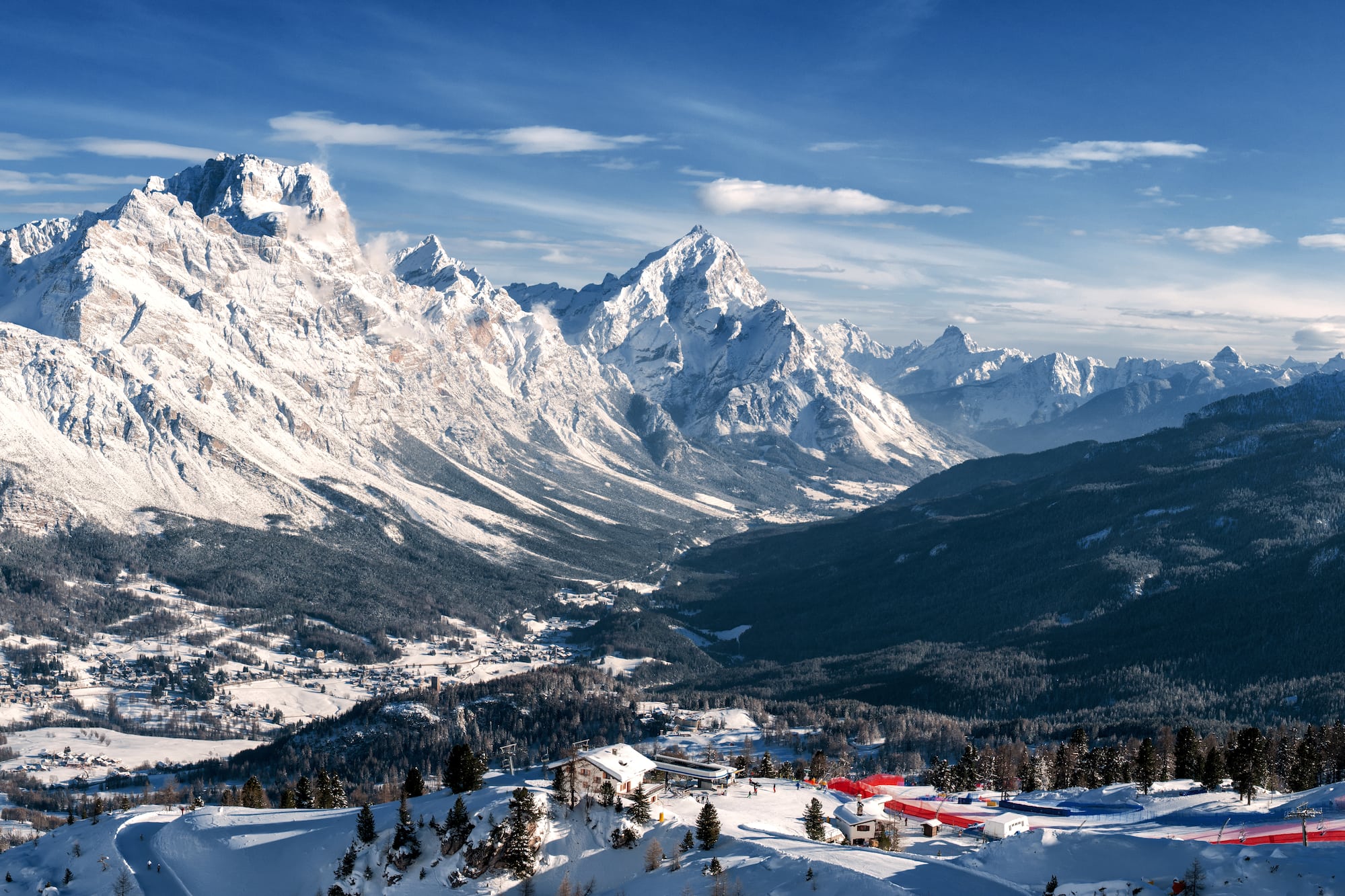 a snowy mountain range with a small village