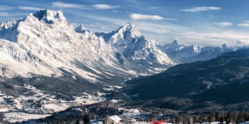 a snowy mountain range with a small village