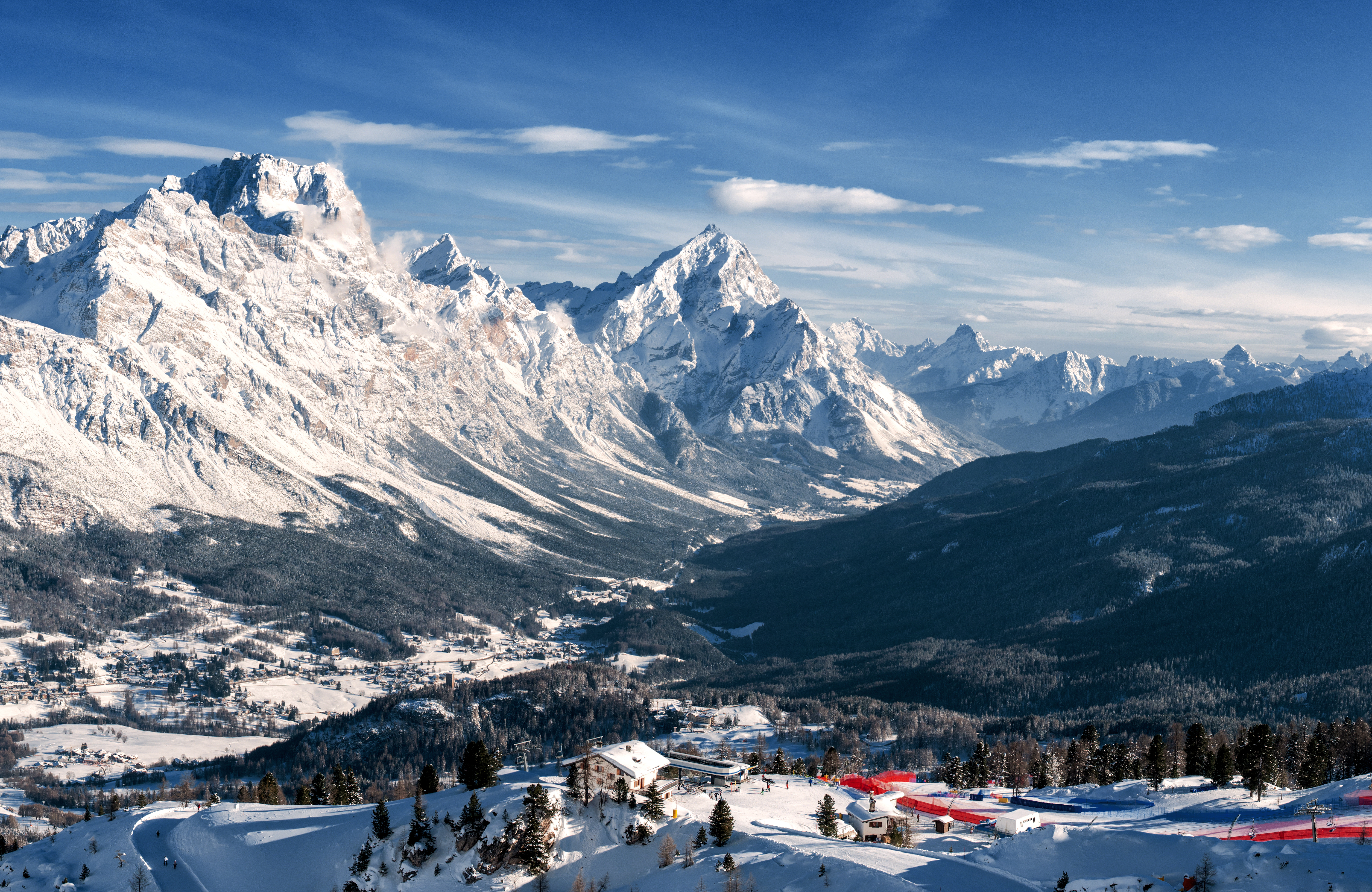 a snowy mountain range with a small village