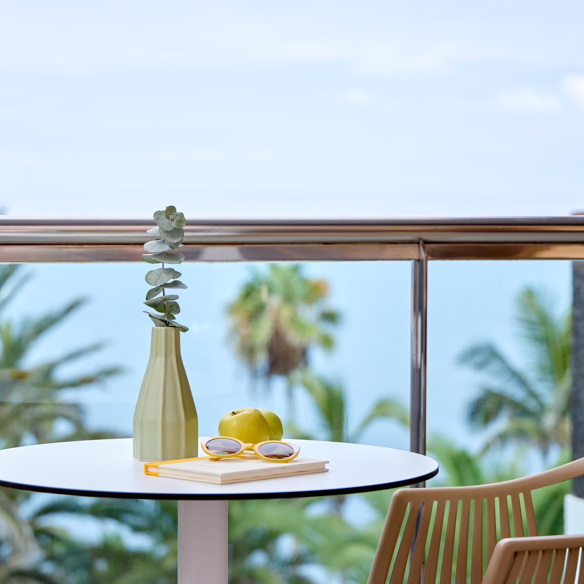 a table with a vase and glasses on it