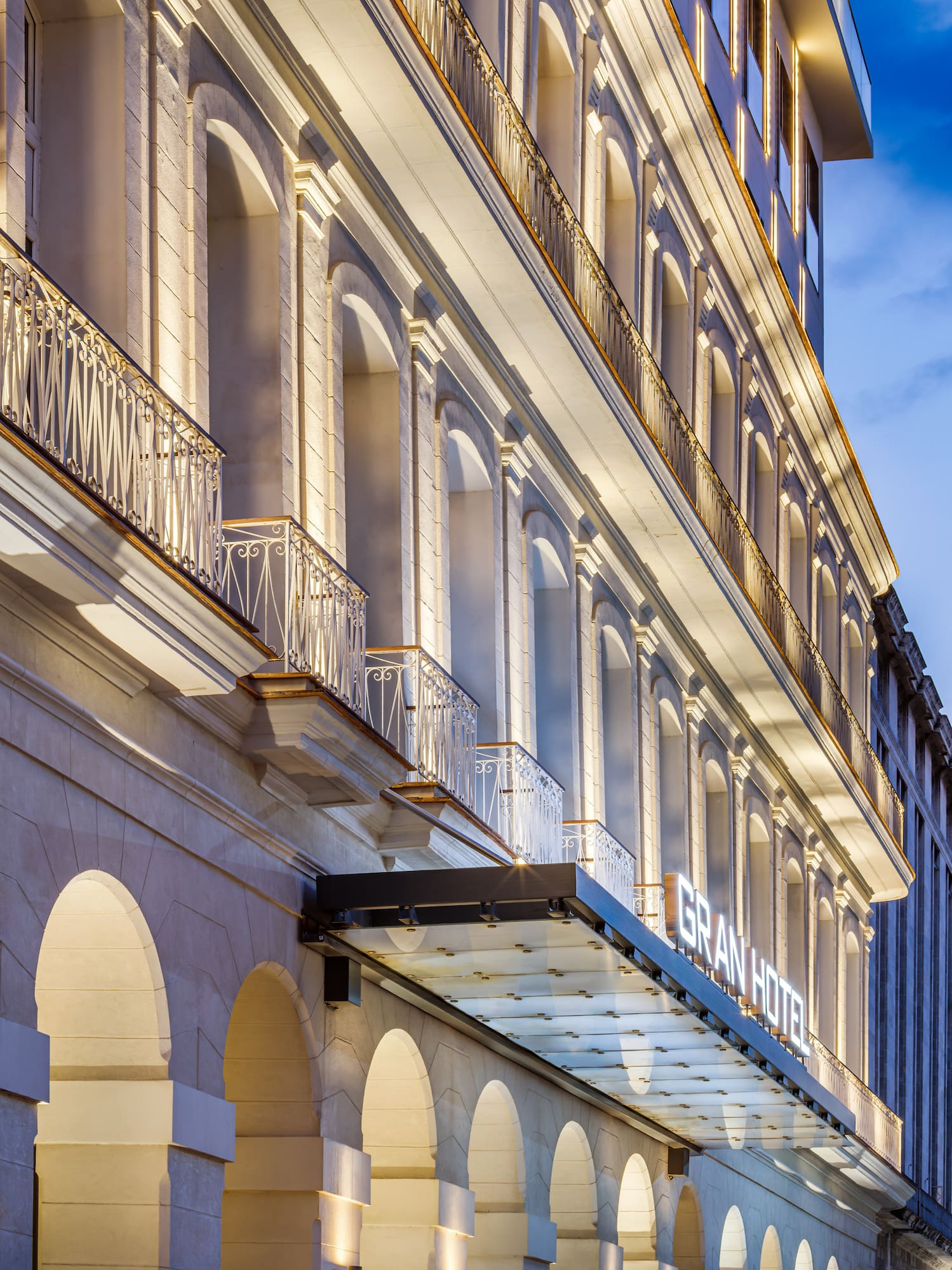 a building with a balcony and a building with a tower