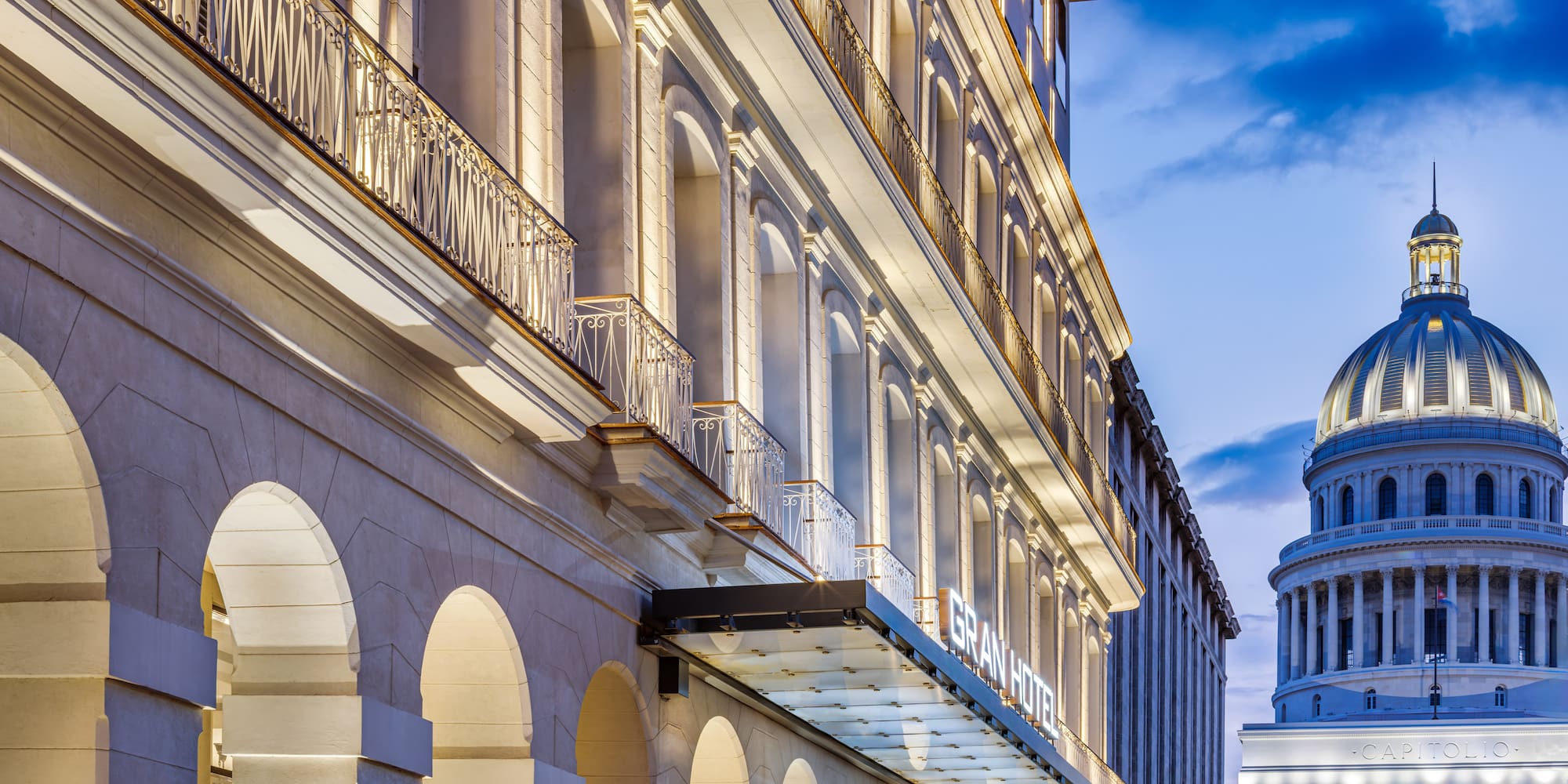 a building with a balcony and a building with a tower