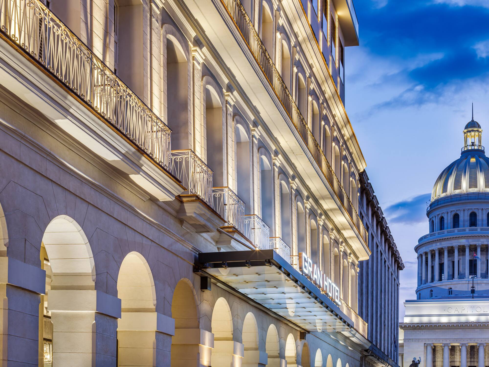 a building with a balcony and a building with a tower