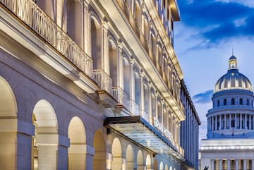 a building with a balcony and a building with a tower