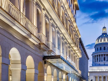 a building with a balcony and a building with a tower