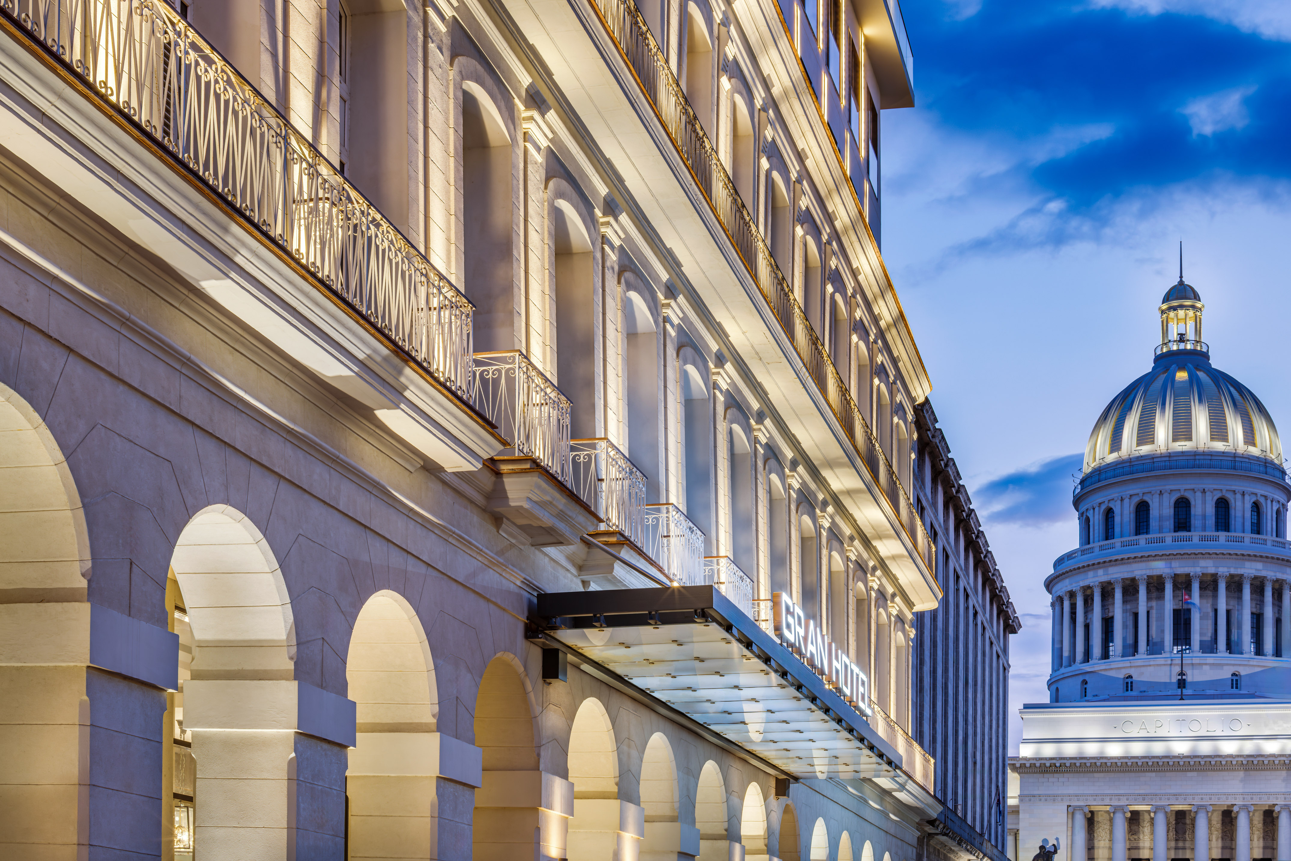 a building with a balcony and a building with a tower