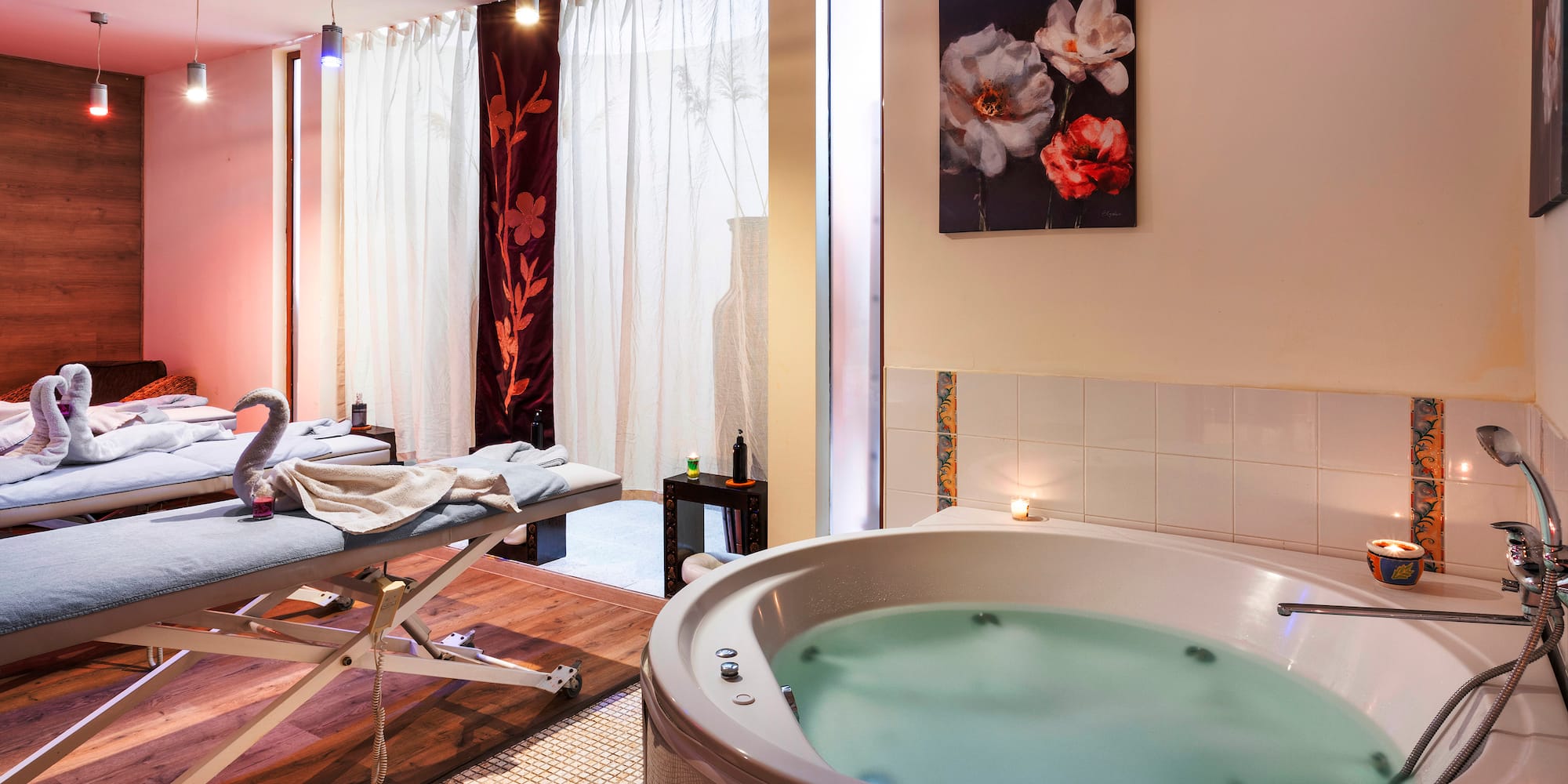 a room with a hot tub and massage table