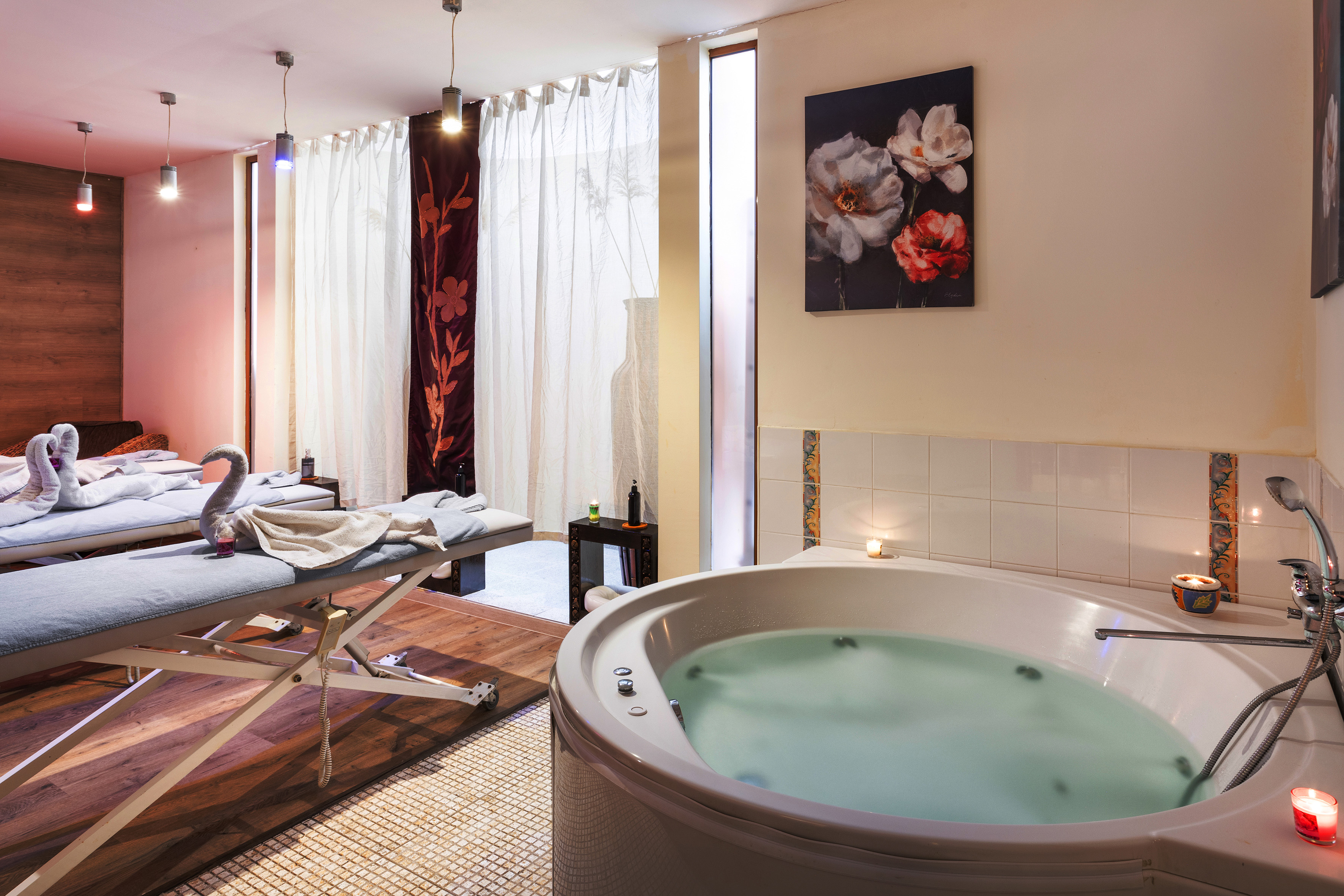 a room with a hot tub and massage table