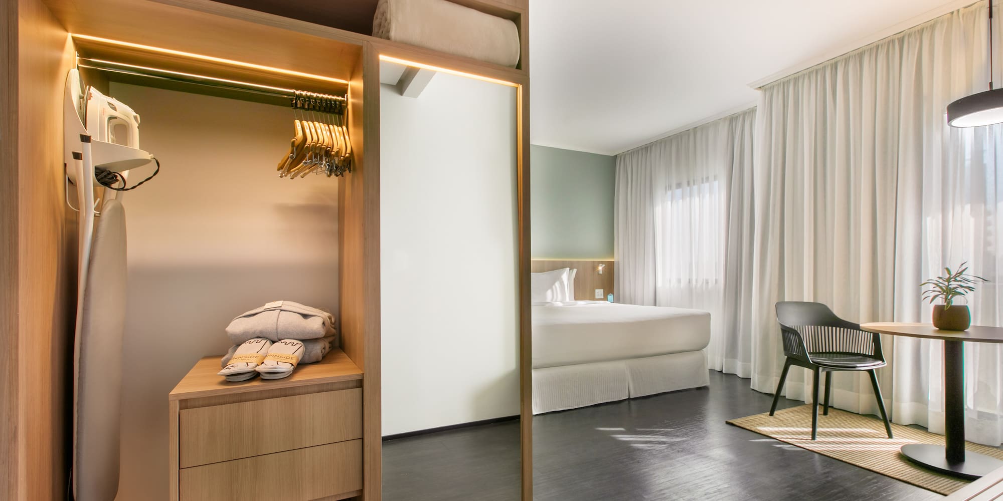 a room with a mirror and a bed