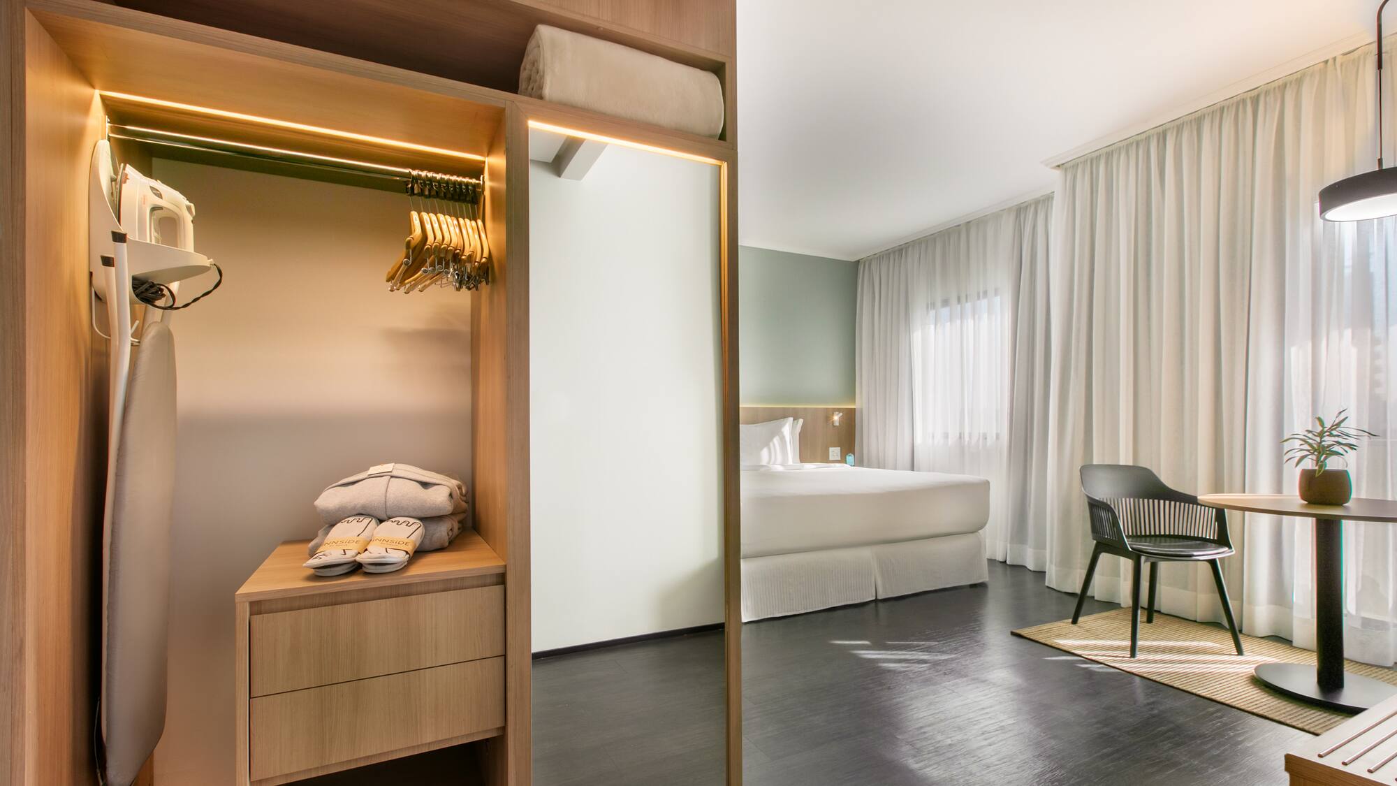 a room with a mirror and a bed