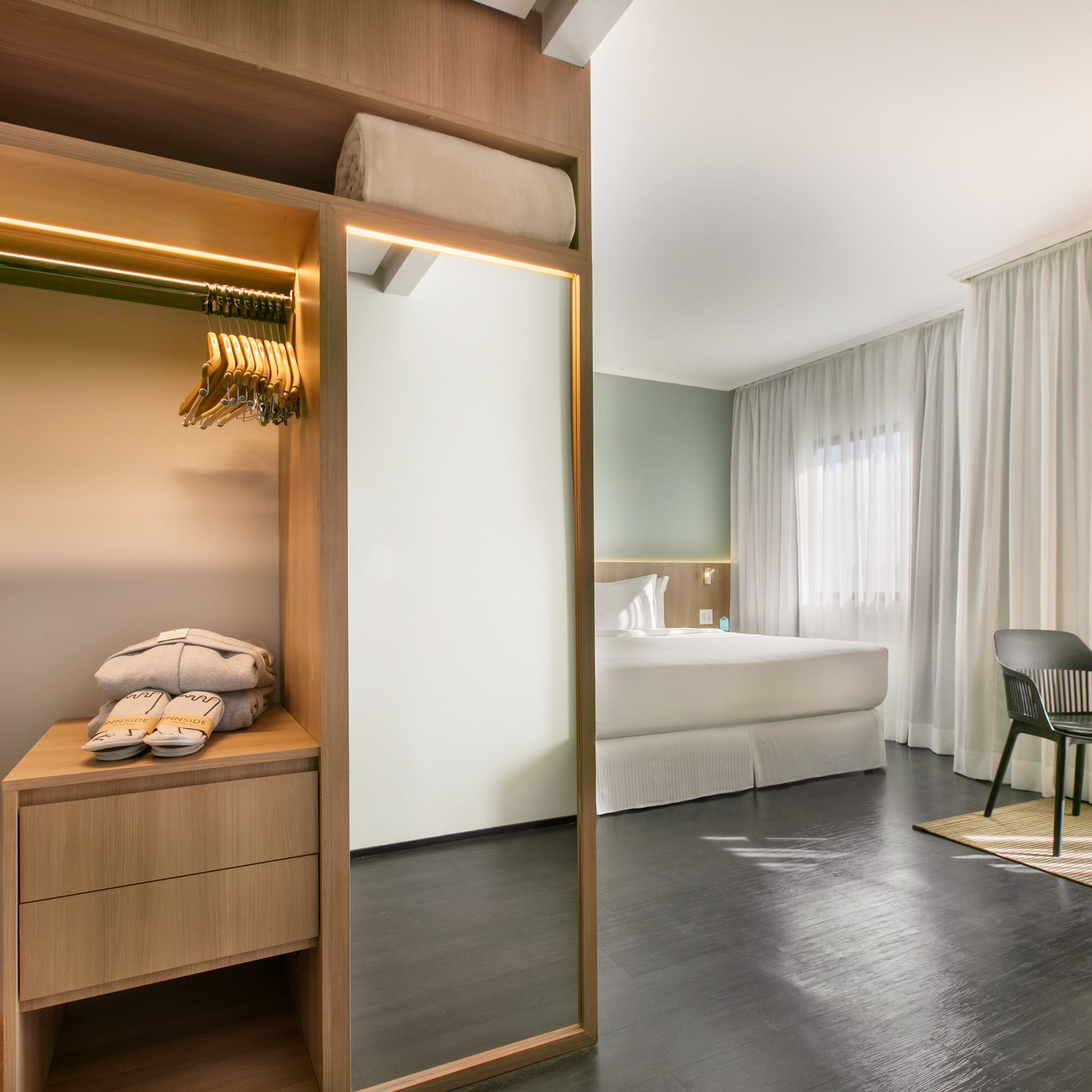 a room with a mirror and a bed