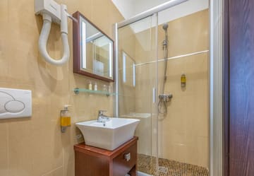 a bathroom with a shower and sink