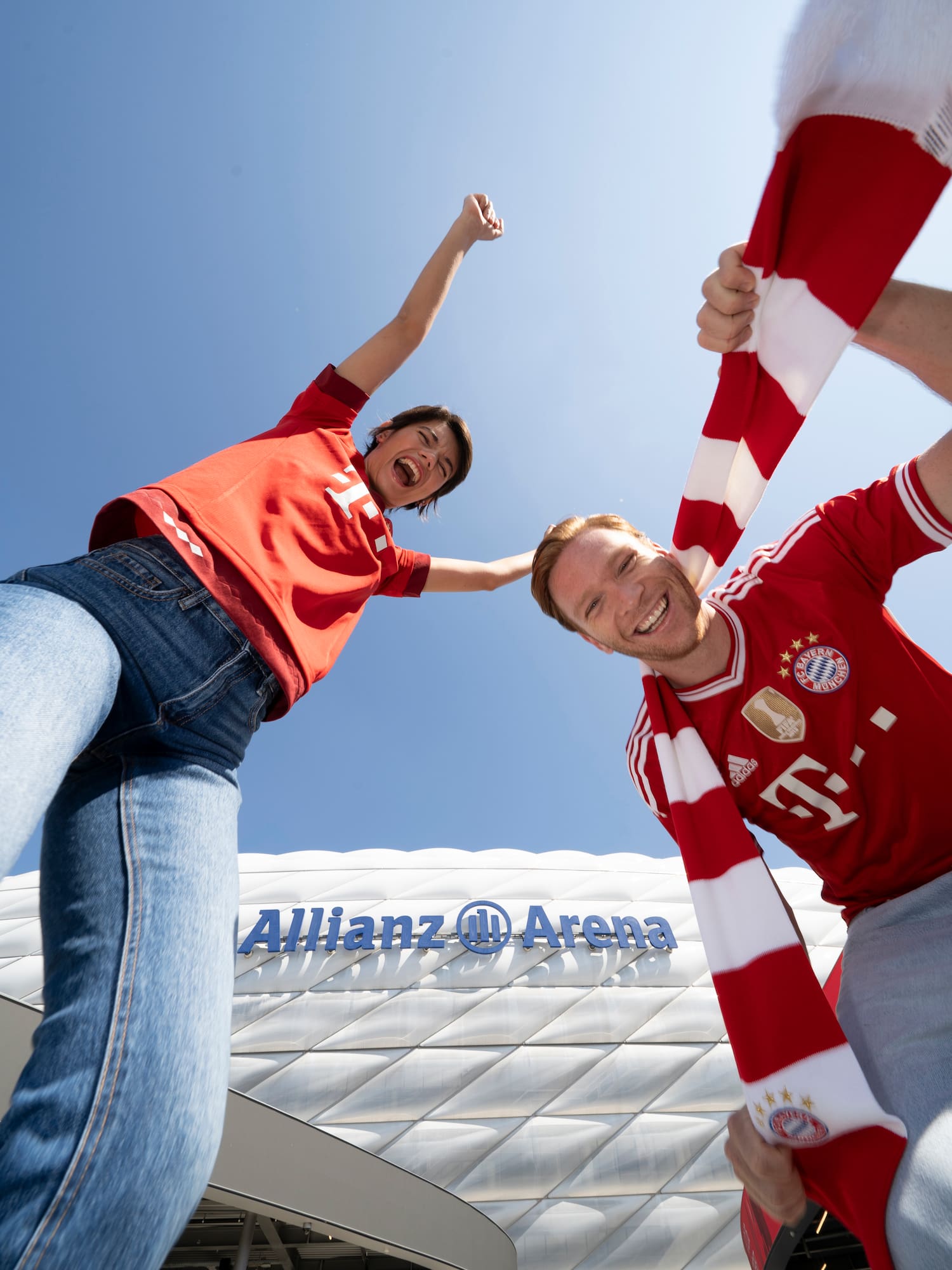 a couple of men holding up a scarf