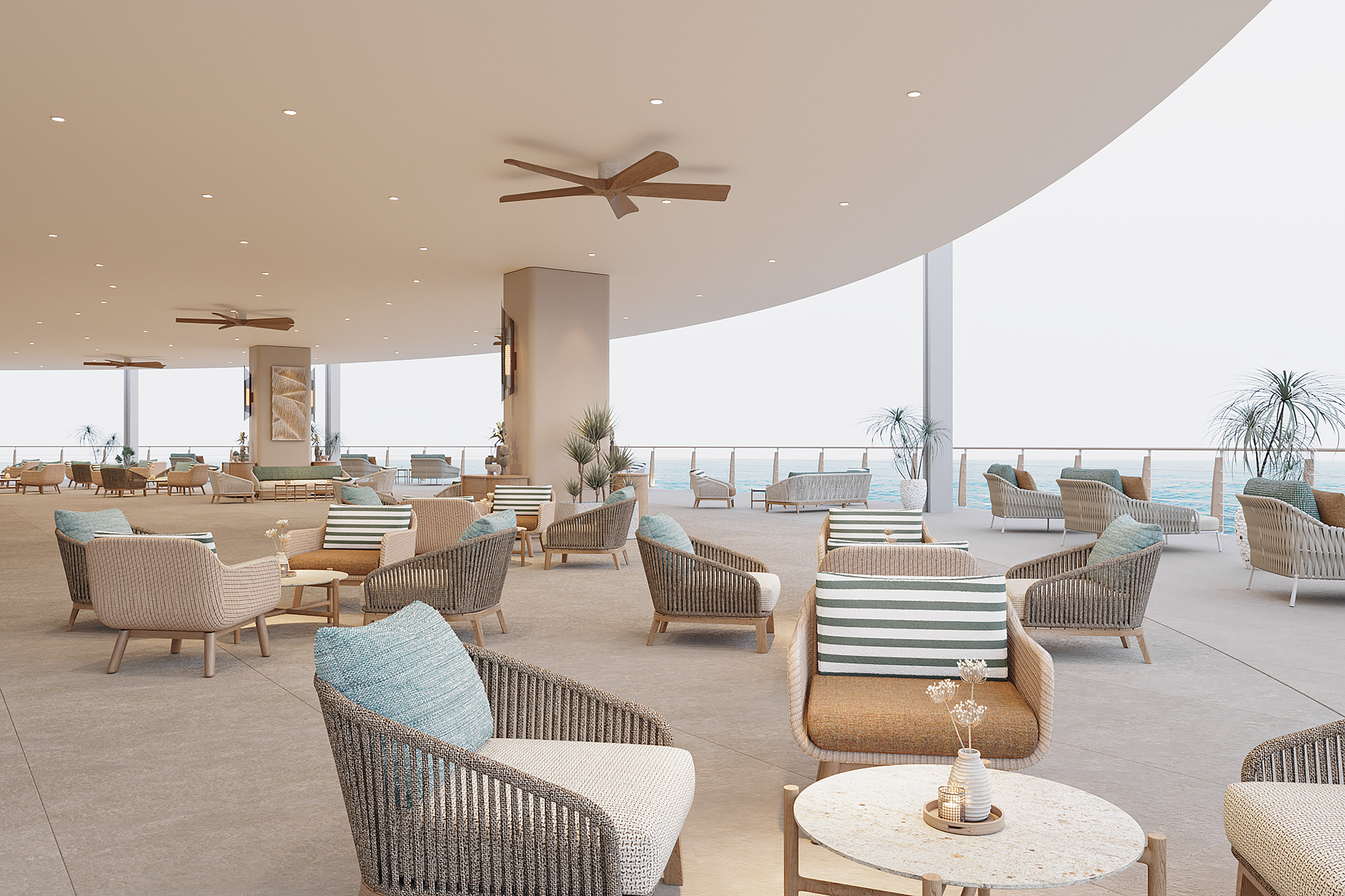 Modern resort lounge with woven seating, ocean view, and ceiling fans.