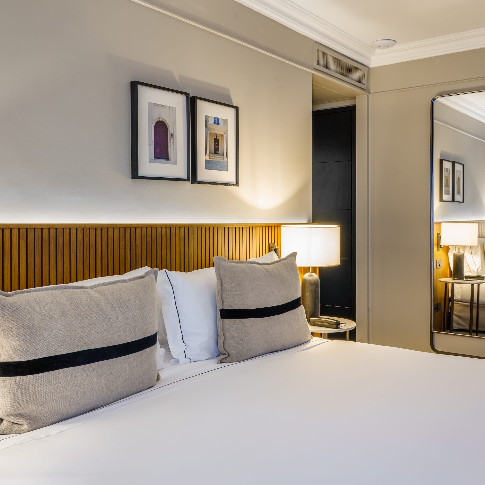 a bed with pillows and a lamp in a room