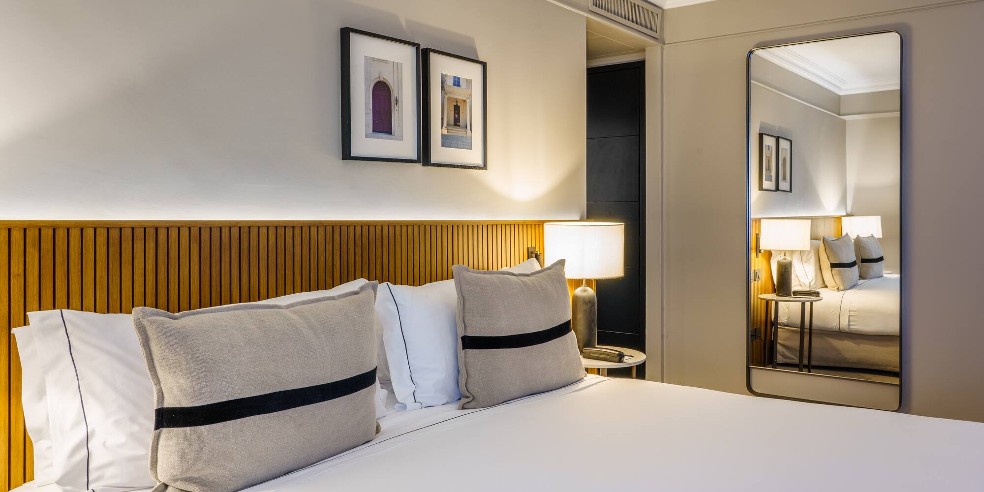 a bed with pillows and a lamp in a room