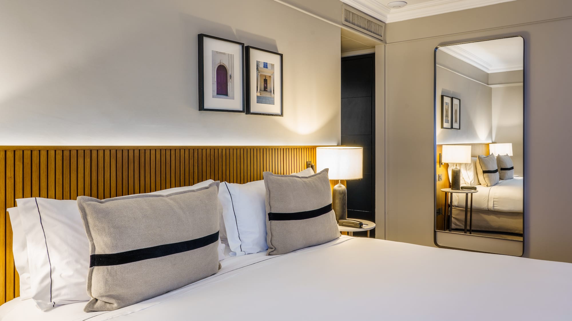 a bed with pillows and a lamp in a room