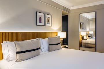 a bed with pillows and a lamp in a room