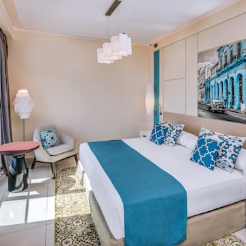 a bedroom with a bed and chair