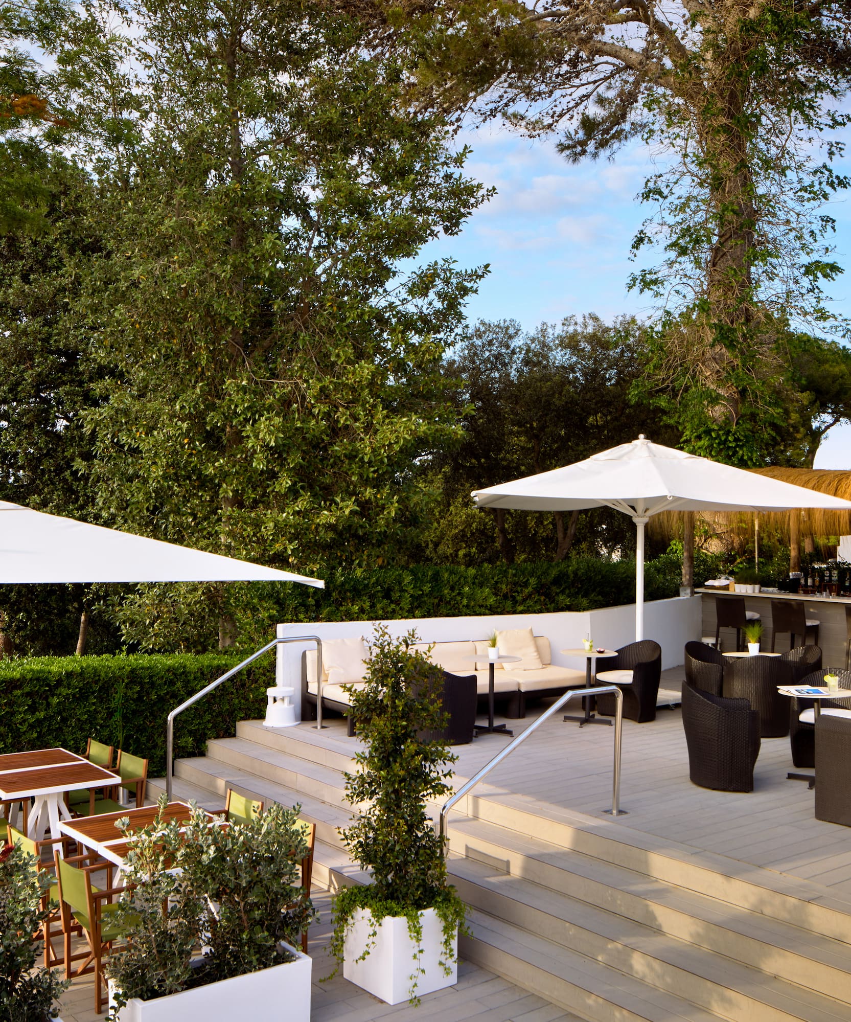 a patio with chairs and umbrellas