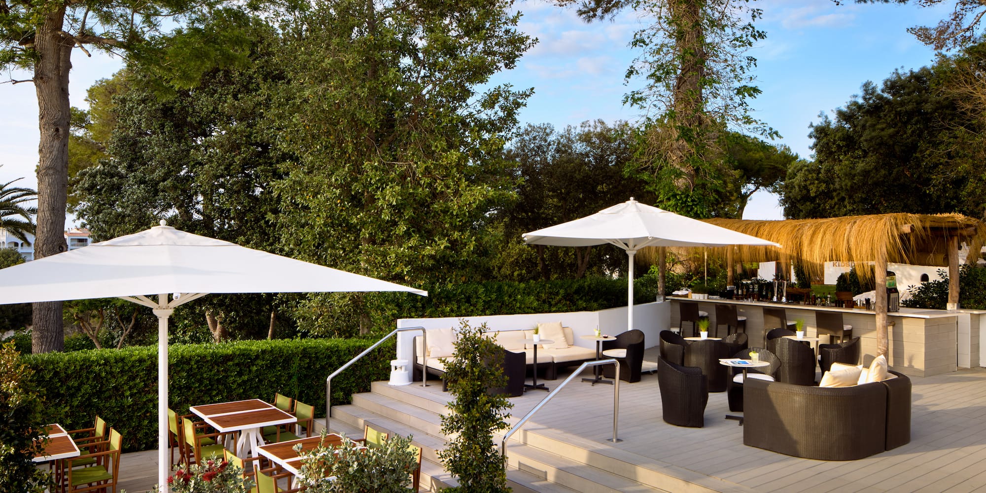 a patio with chairs and umbrellas