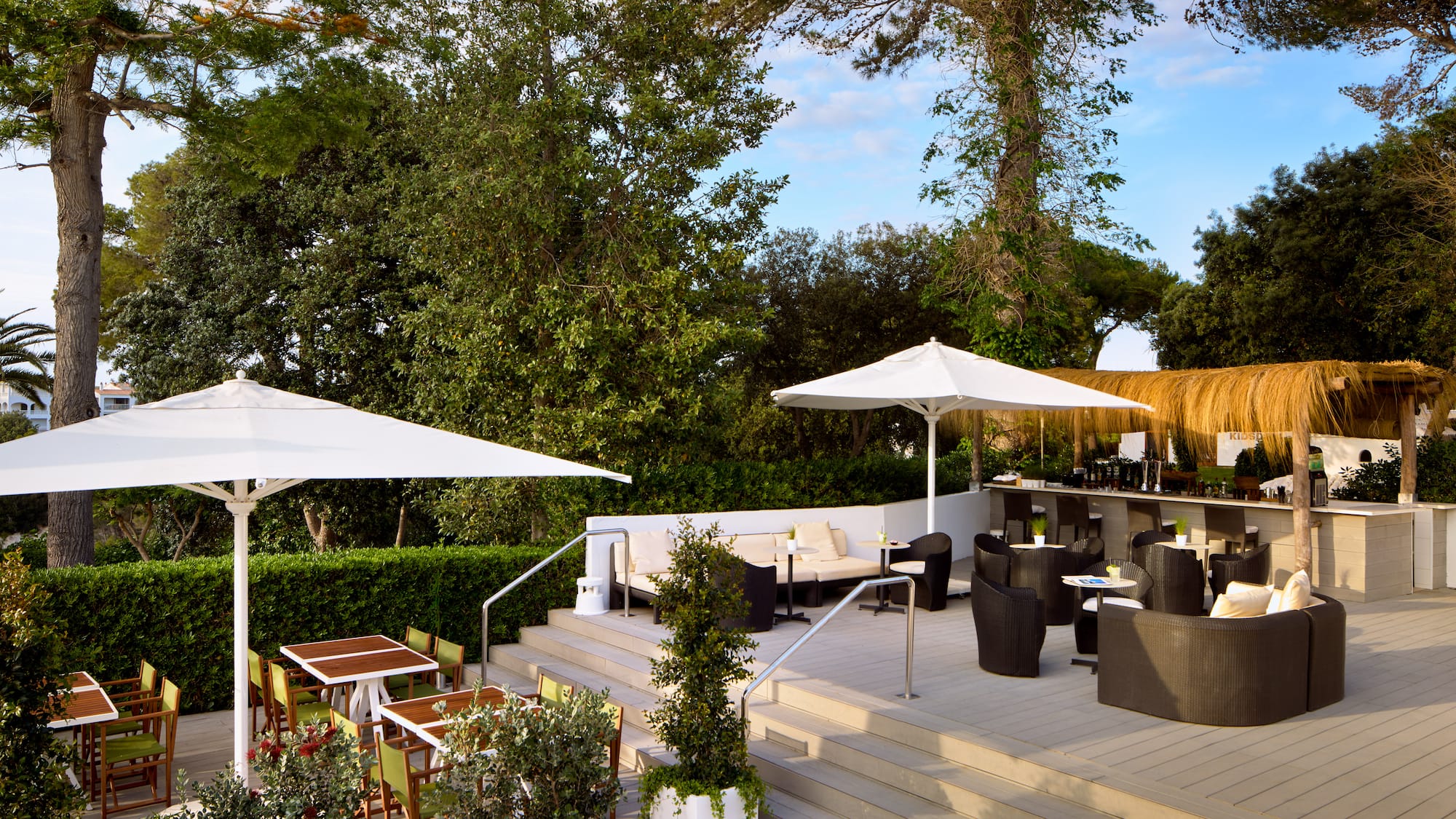 a patio with chairs and umbrellas