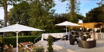 a patio with chairs and umbrellas