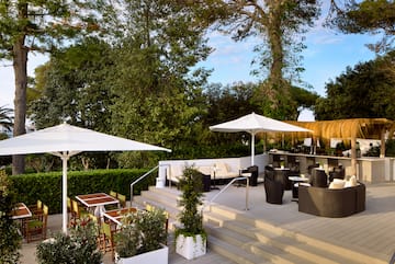 a patio with chairs and umbrellas