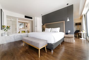 a bedroom with a bed and a bathtub