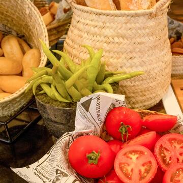 a basket of tomatoes and peppers