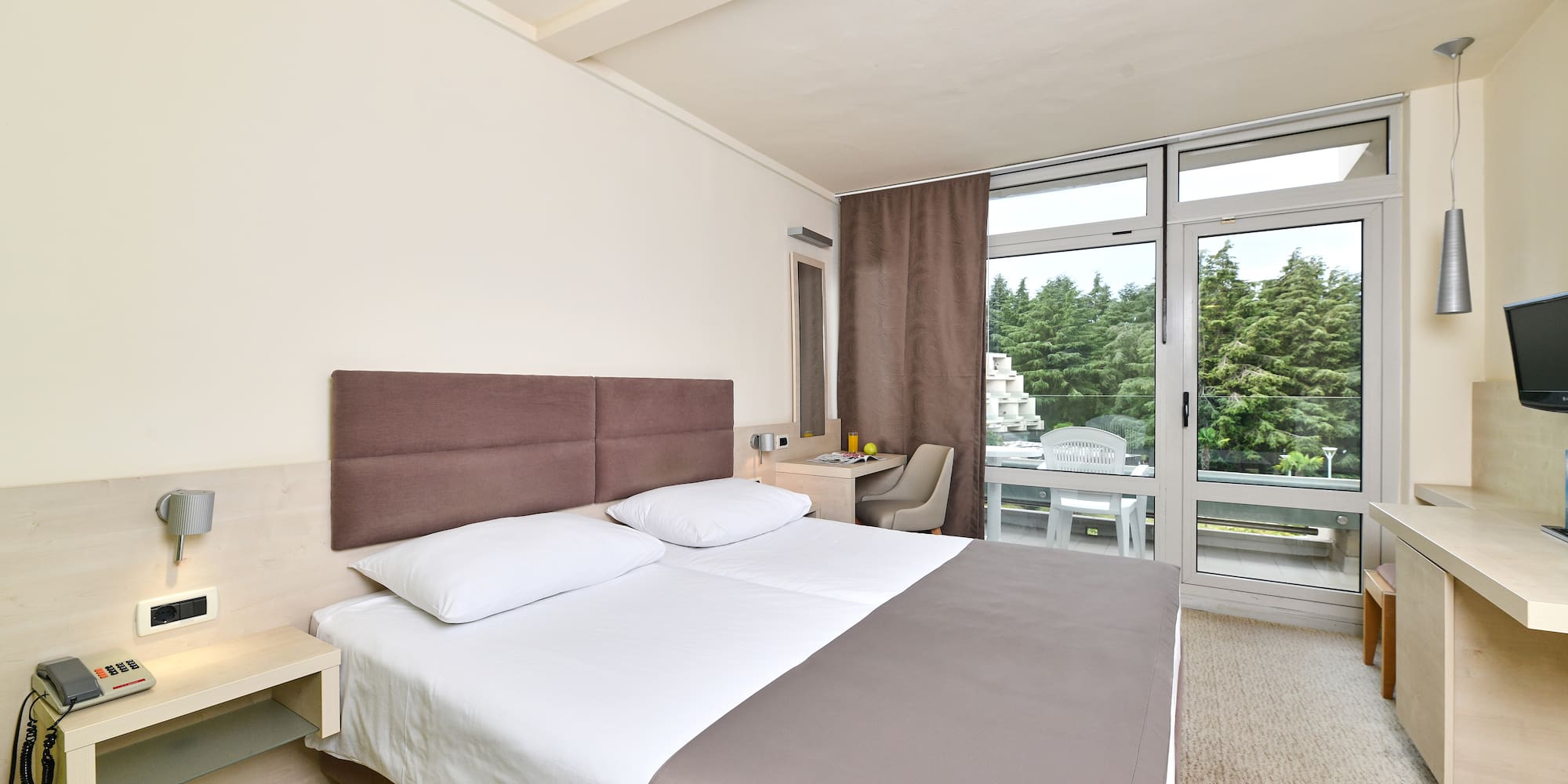 a bed in a room with a glass door