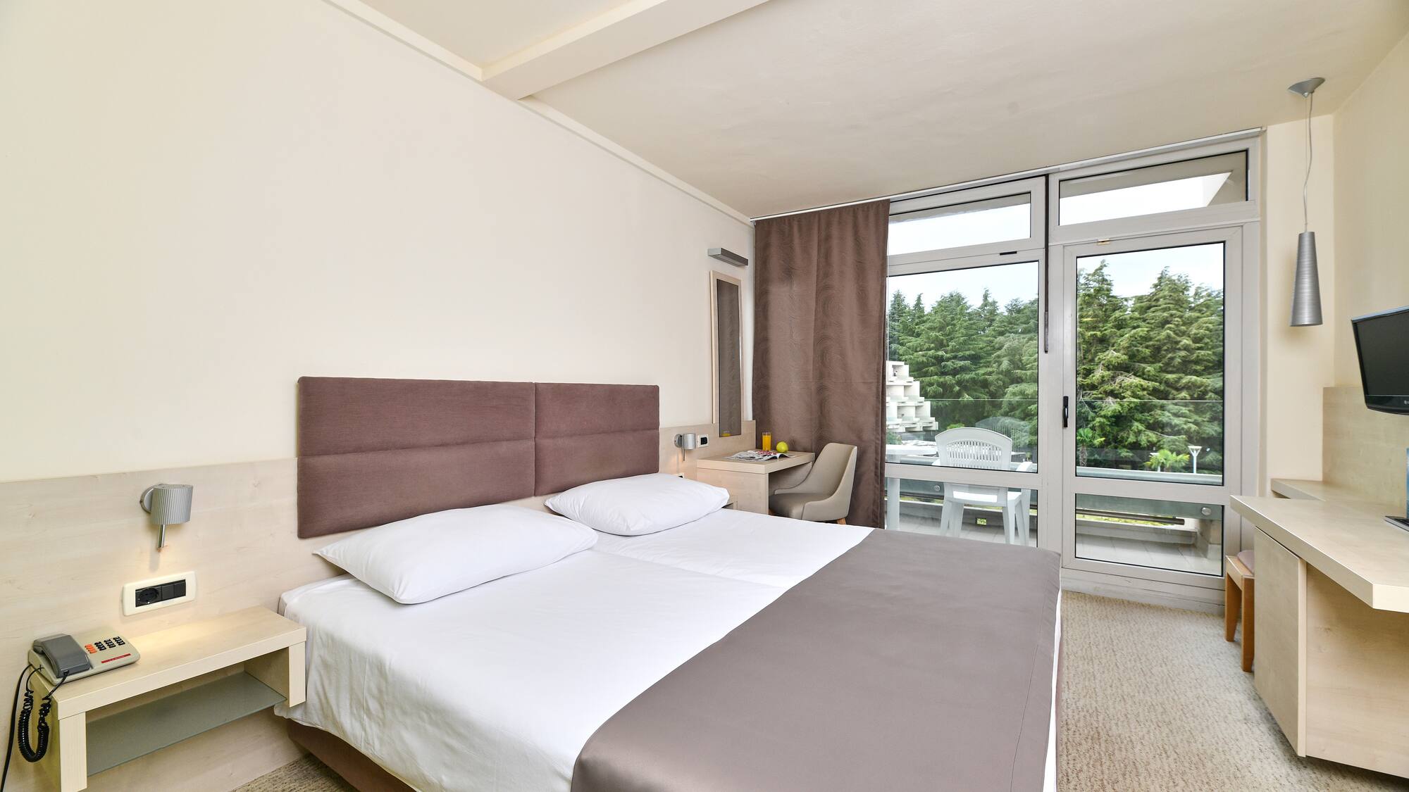 a bed in a room with a glass door