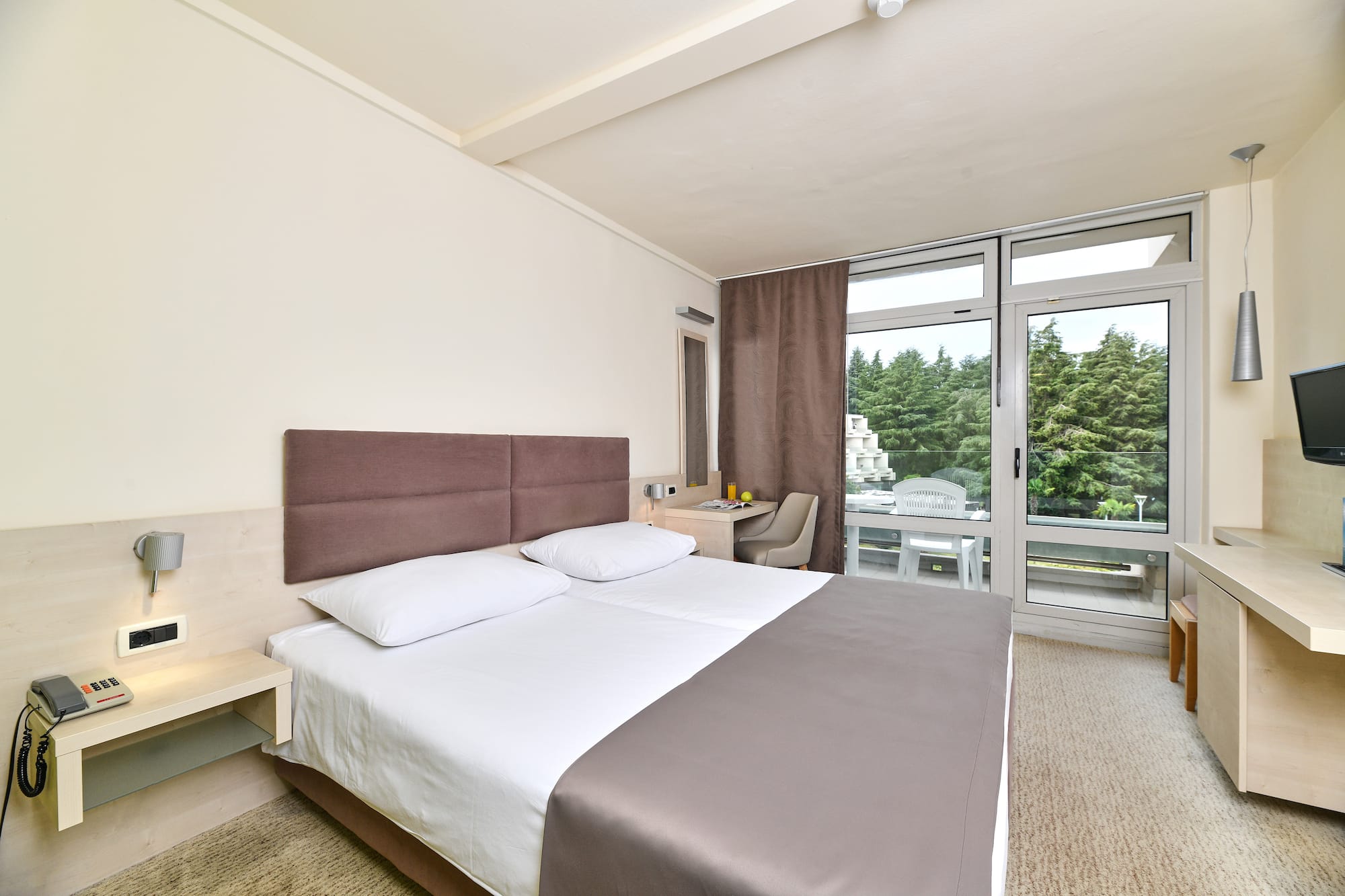 a bed in a room with a glass door