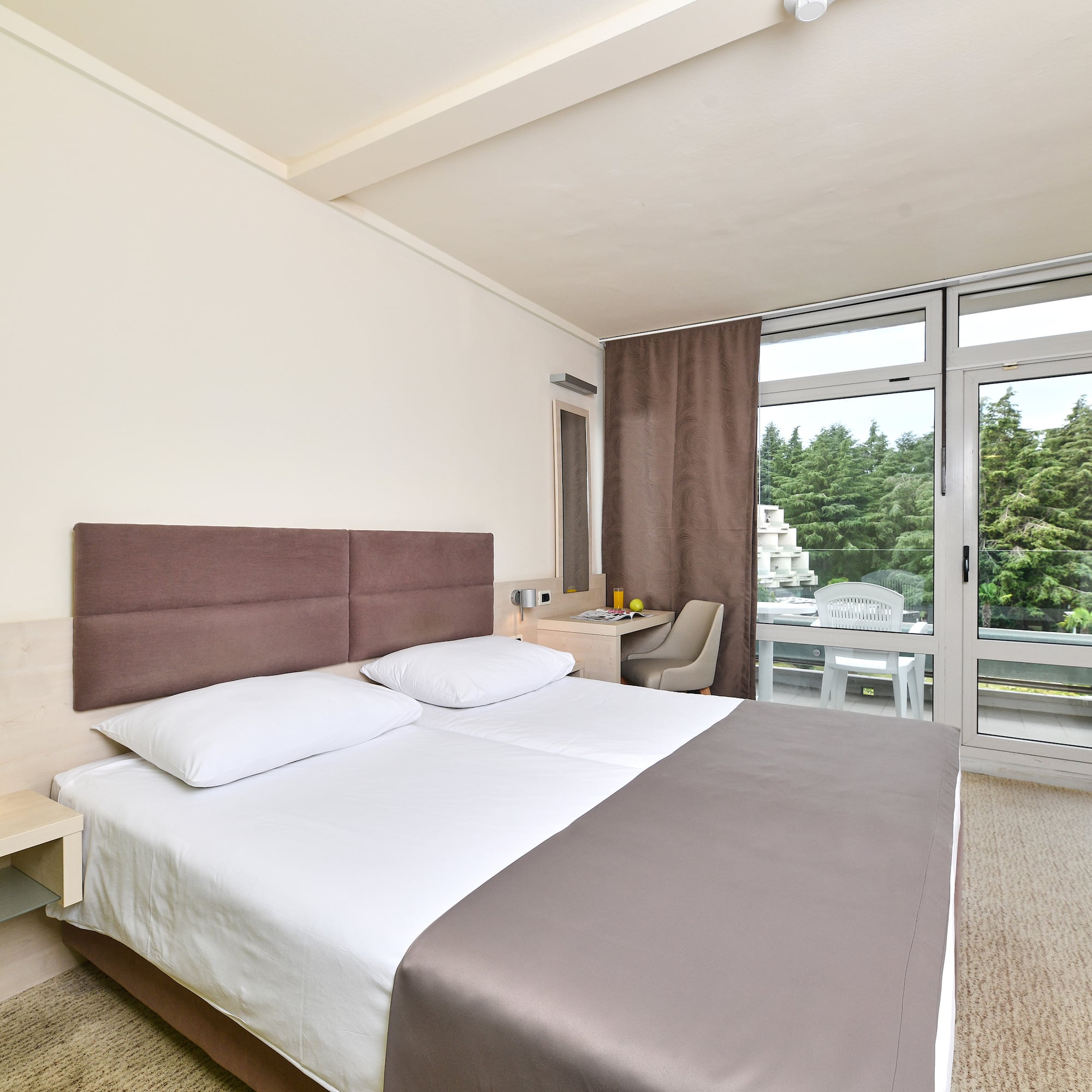 a bed in a room with a glass door