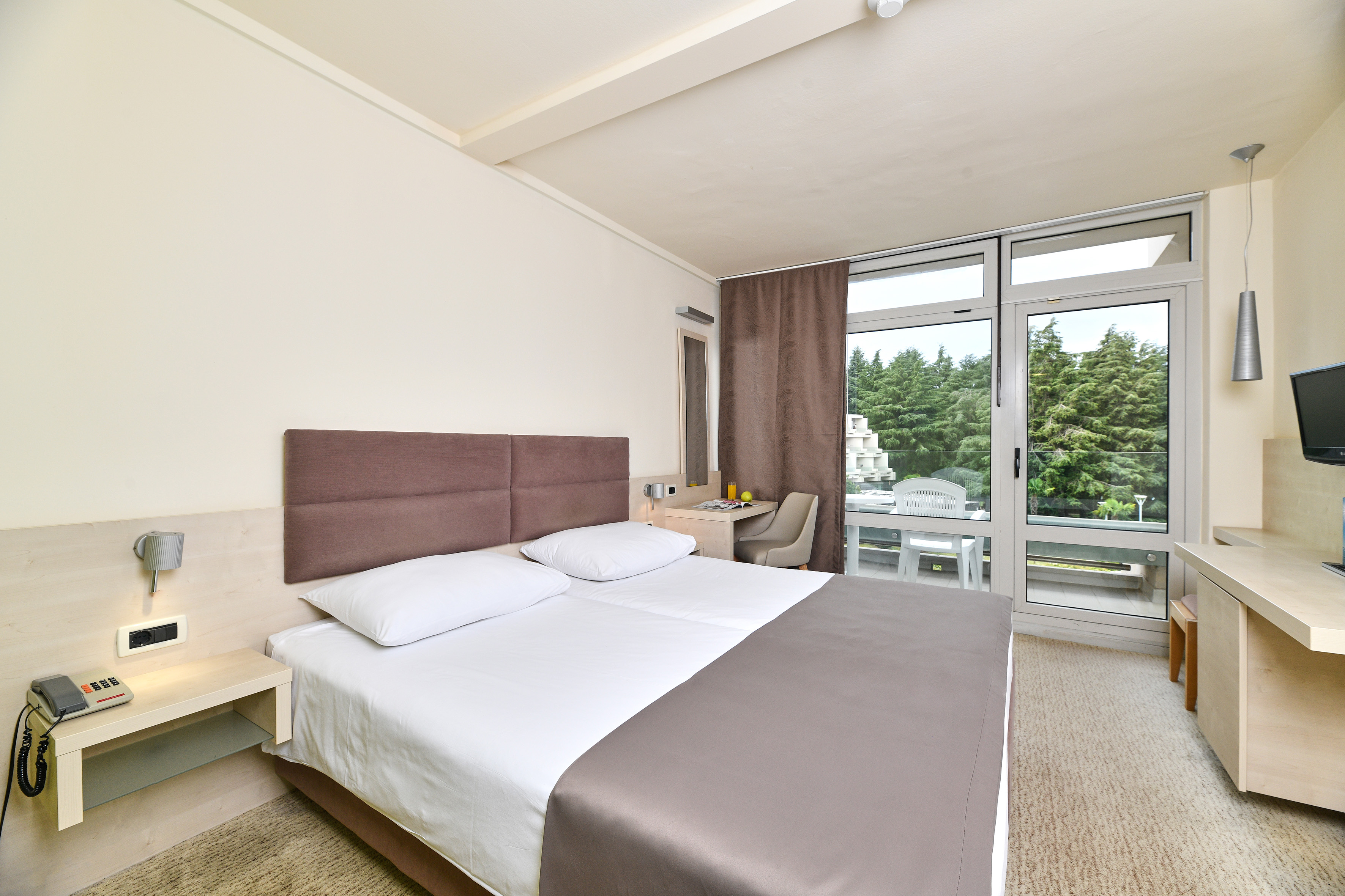 a bed in a room with a glass door