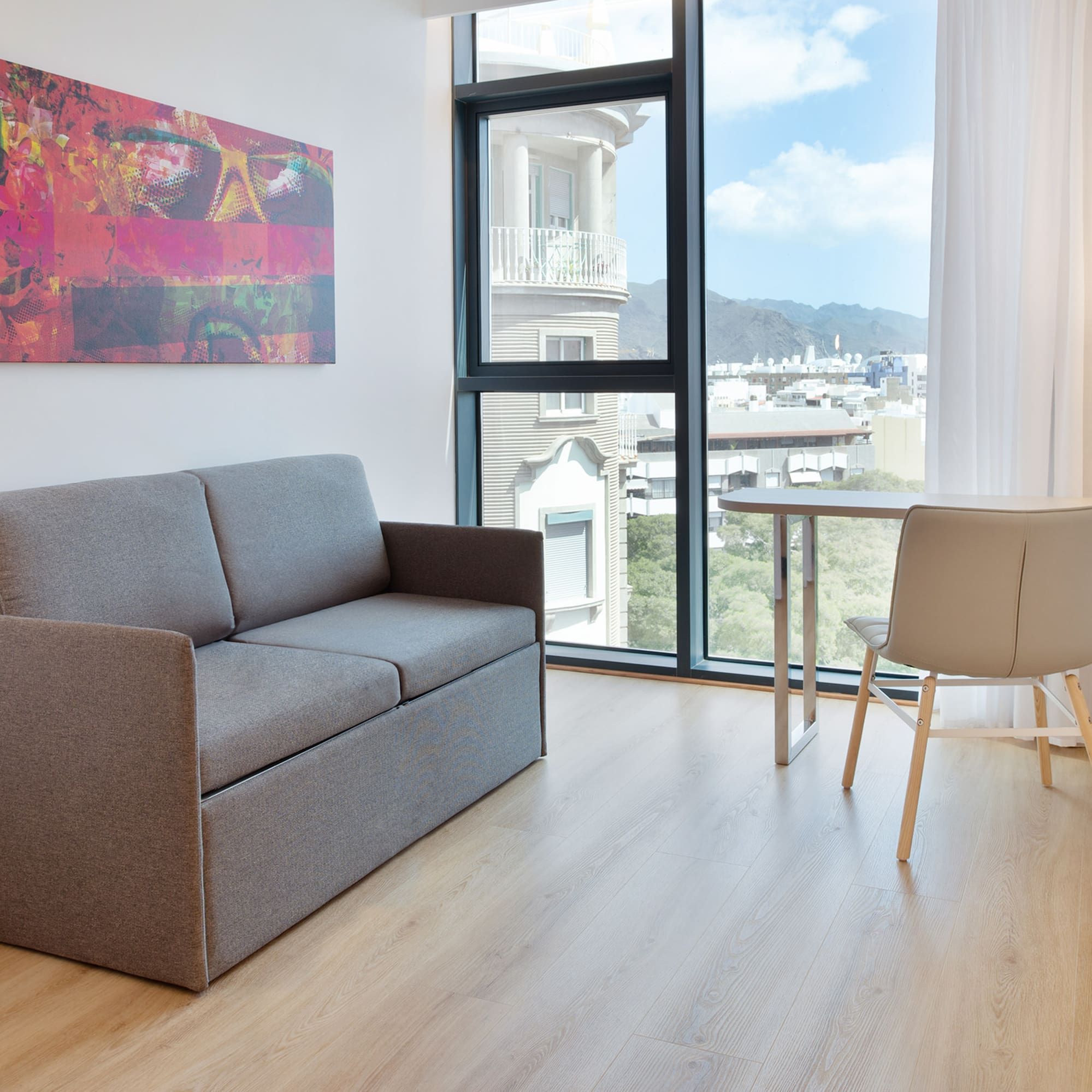 a couch and table in a room with a window