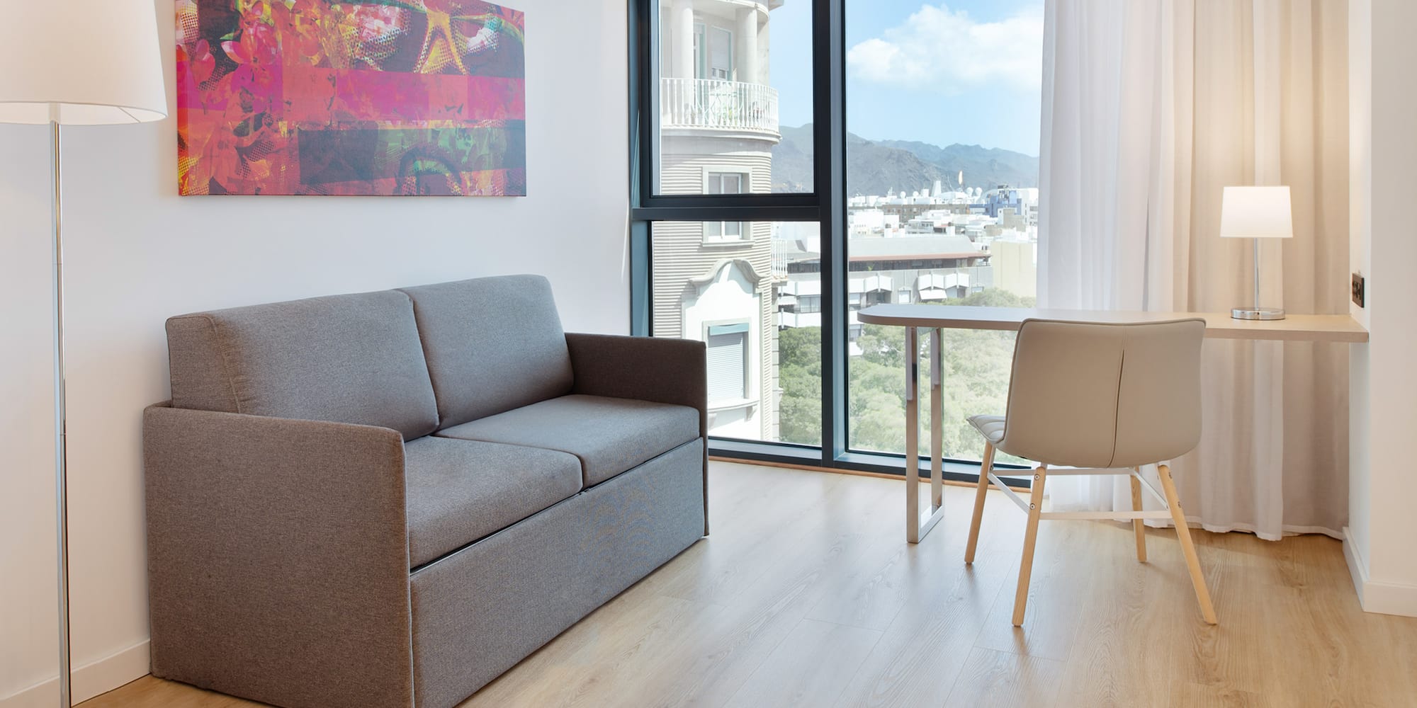 a couch and table in a room with a window