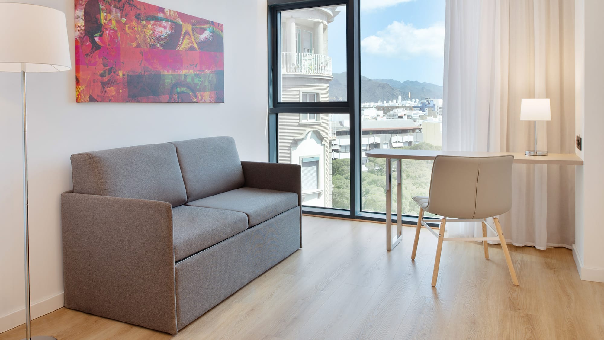 a couch and table in a room with a window