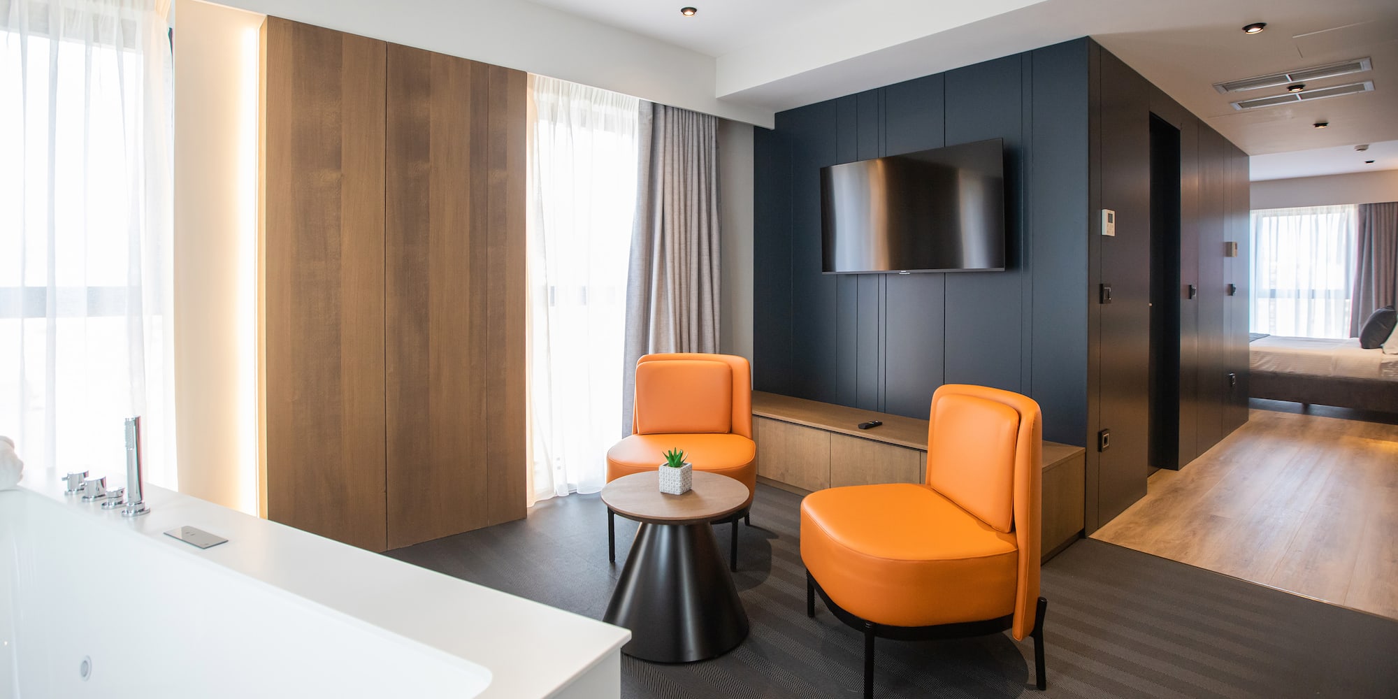 a room with orange chairs and a tv